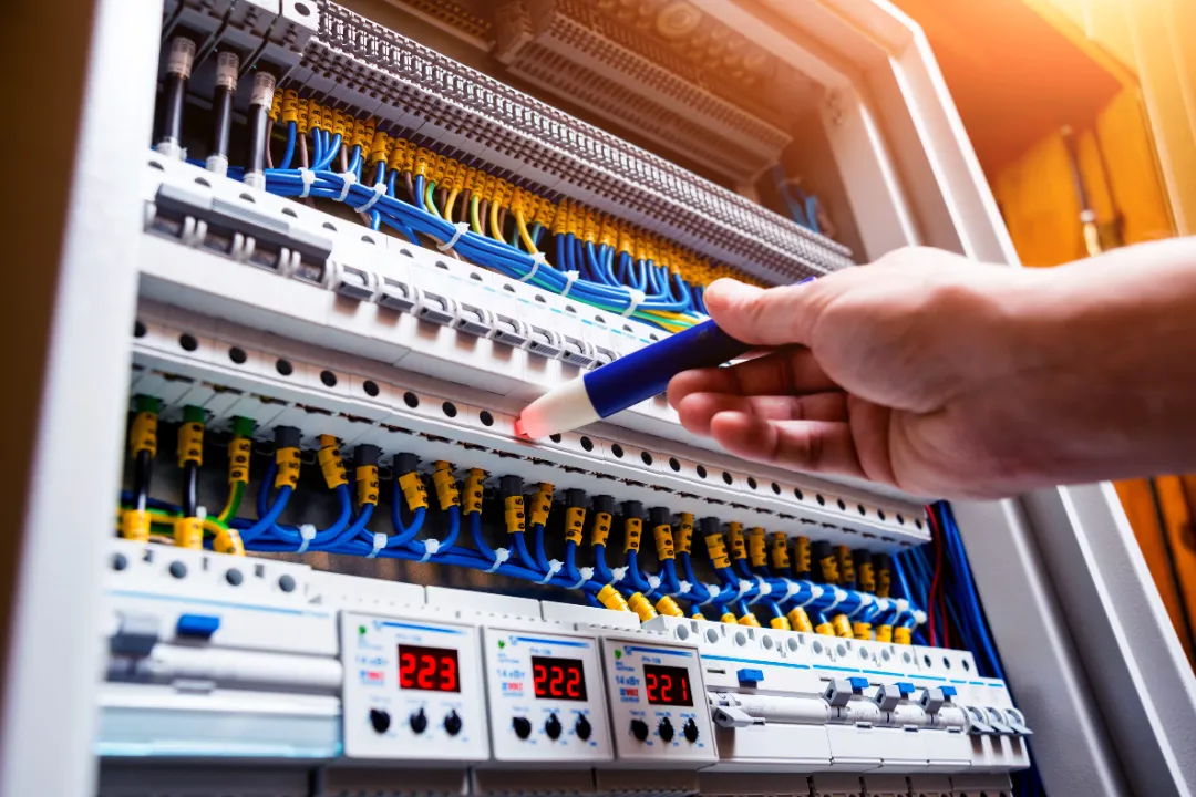 150838532_l Checking voltage in switchboard with a detector. Electrical background